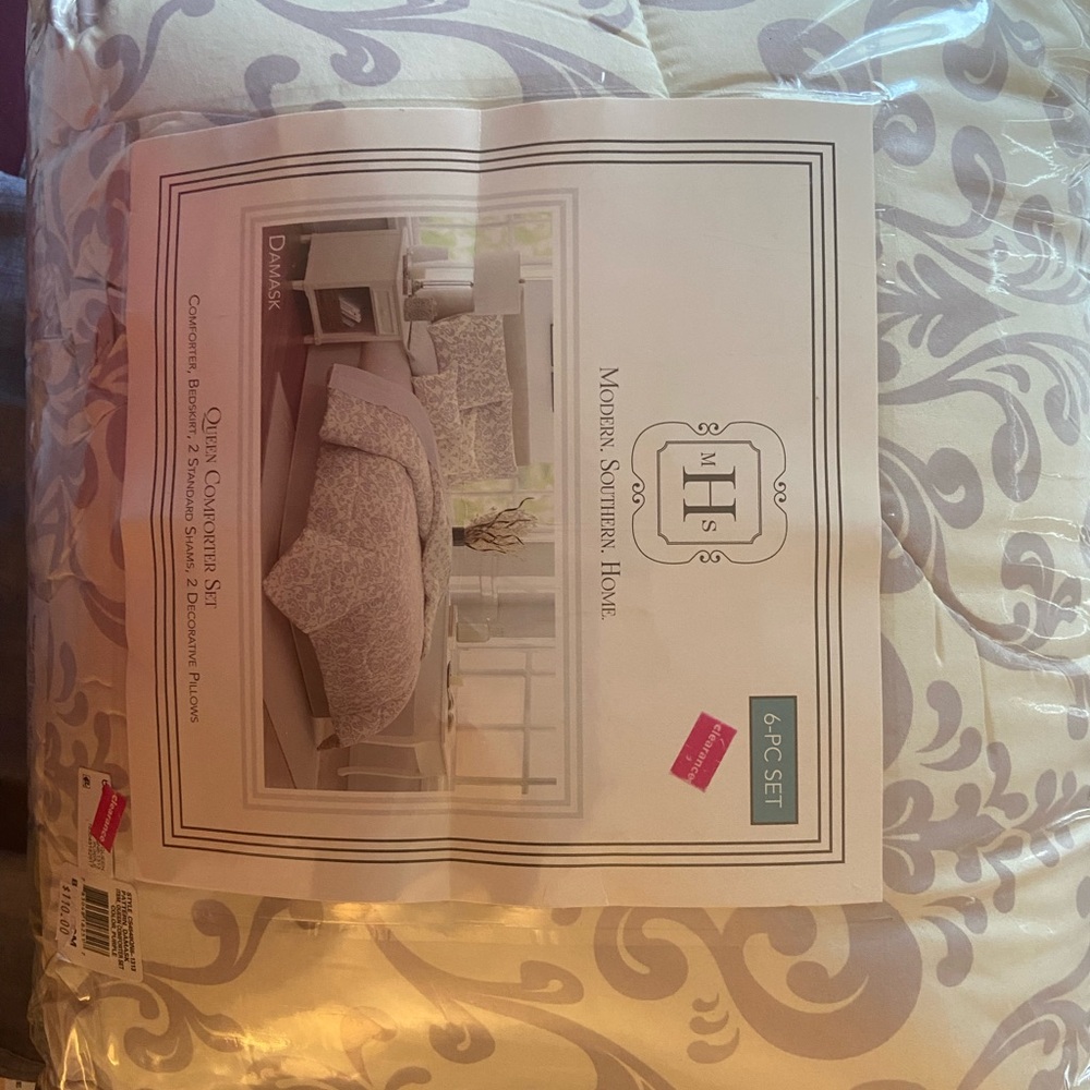 Queen size comforter set in lavender and white.